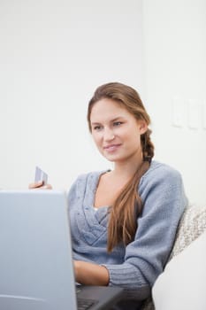 Woman sitting while using a computer indoor
