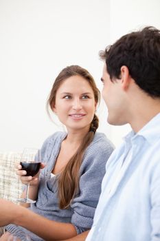 Young Couple watching each other while holding a glass