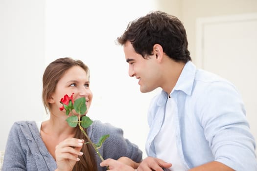 Man offering a rose to a Woman  indoors
