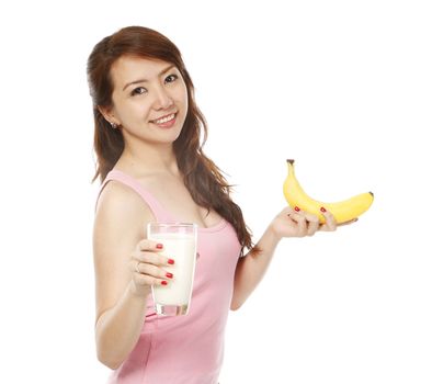 A fit young woman holding a banana and a glass of milk (on white background)