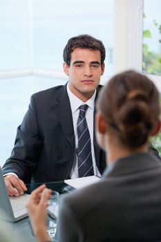 Businessman looking at his client in an office