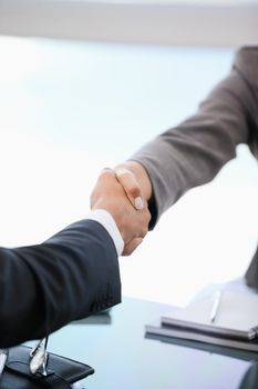 Two people shaking hands in an office