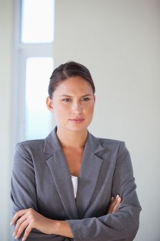 Businesswoman crossing arms in an office