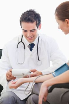 Doctor auscultating a patient against white background