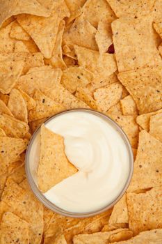 Chips surrounding a  bowl of white dip