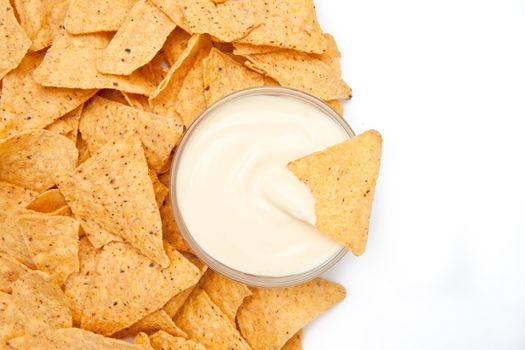 Bowl of white dip surrounded by chips