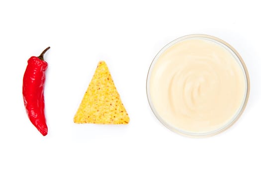 Bowl of dip nacho and pepper side by side against a white background