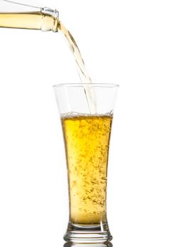 Glass of beer being poured from a bottle against a white background