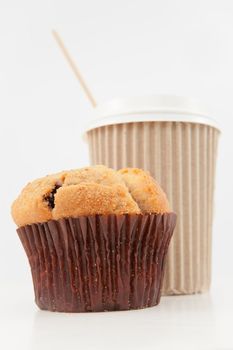 Muffin and a cup of coffee placed together against a white back ground