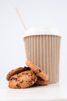 Cookies and a cup of coffee placed together against a white background