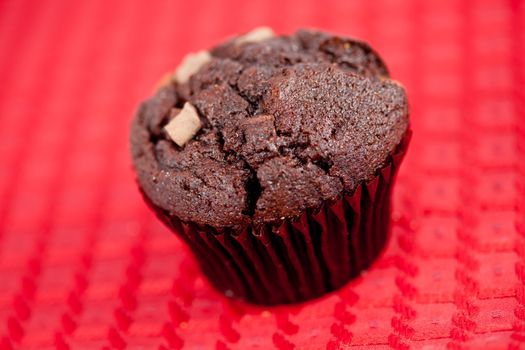 Chocolate muffin on a red tablecloth