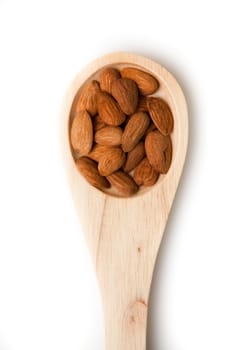 Wooden spoon with almonds against a white background