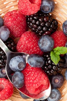 Berries eating in a basket in a high angle view