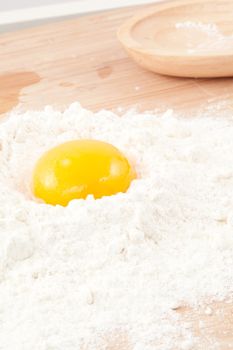 Egg yolk on the flour in a high angle view