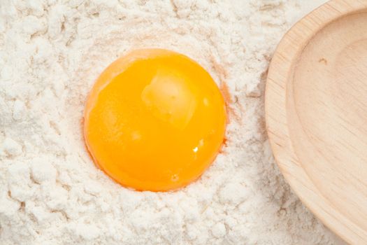 Egg yolk on the flour in a high angle view