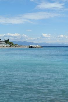 Beautiful view of the sea, under blue cloudy sky