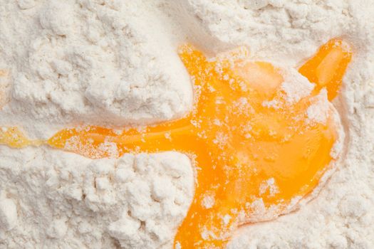 Egg yolk on the flour in a high angle view
