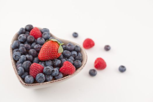 Bowl with berries against a white background