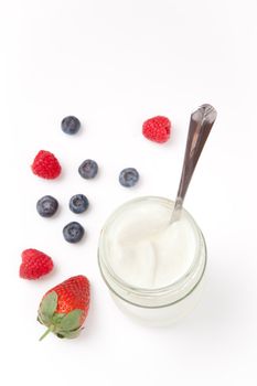 White yogurt and berries against a white background