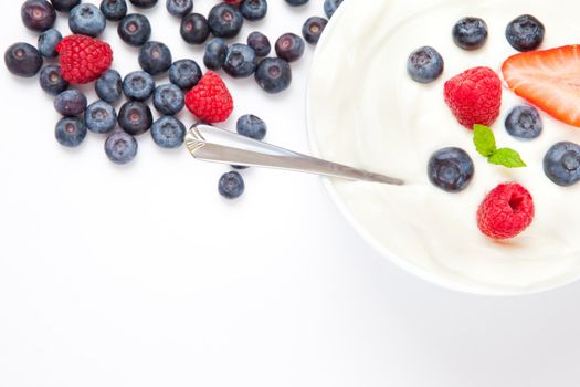 Dessert of berries with cream  against a white background