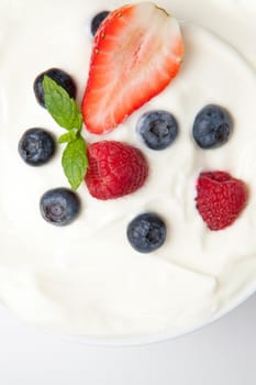 Berries in a white  cream against a white background