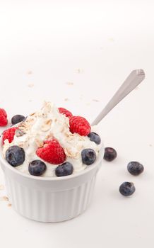 Healthy dessert with berries against white background