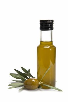 Glass bottle of premium virgin olive oil and some olives with leaves isolated on a white background