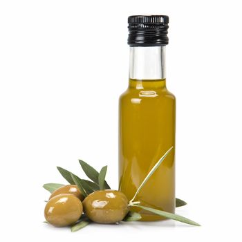 Glass bottle of premium virgin olive oil and some olives with leaves isolated on a white background