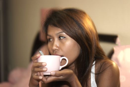 Thai lady drink coffee. Summer 2012.