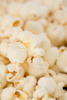 Close up on many blurred pop corn against a black background