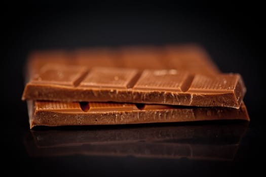 Blurred bar of chocolate against a black background