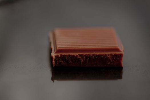 A piece of chocolate on a grey table