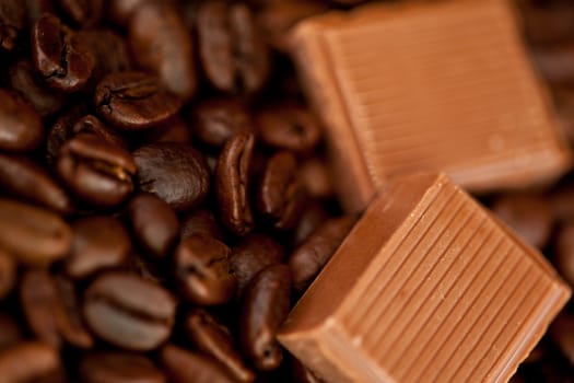 Close up of chocolate pieces and coffee beans side by side