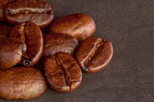 Many coffee seeds laid out together on a black table