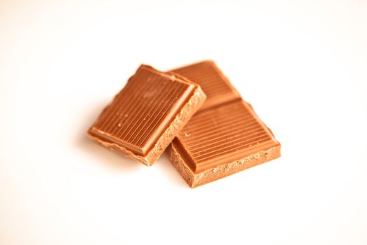 Chocolate pieces against a white background