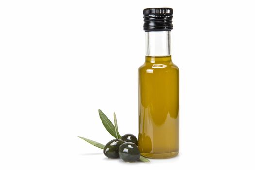 Glass bottle of premium virgin olive oil and some olives with leaves isolated on a white background