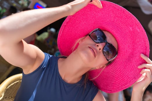 Young attractive woman in red hat and sunglasses