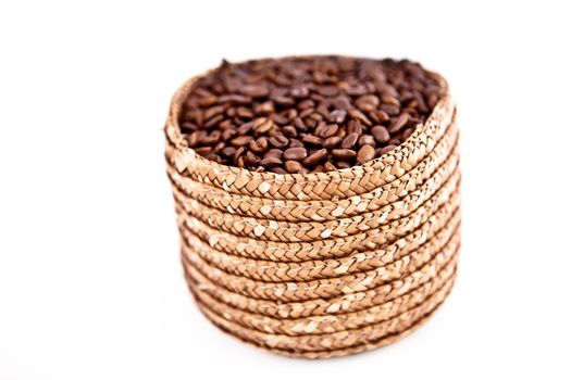 A basket full of coffee seeds against a white background