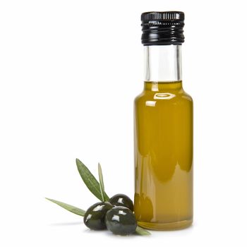 Glass bottle of premium virgin olive oil and some olives with leaves isolated on a white background