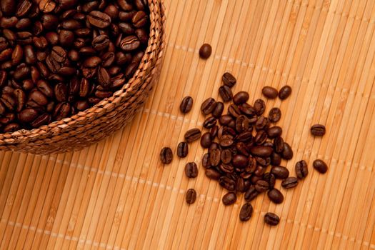 Close up of seeds in front of a basket full of coffee seeds