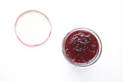 Jar of jam against a white background