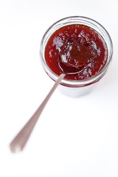 Jar of jam ready to eat  against a white background