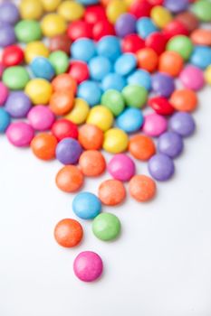 Multicolored chocolate candies against a white background