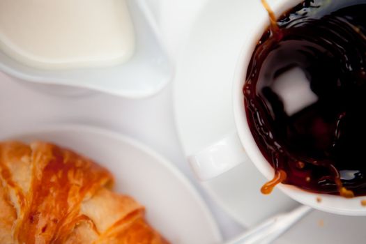 Splashing of coffee against a white background