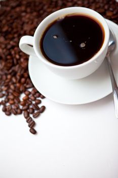 Espresso and beans against a white background