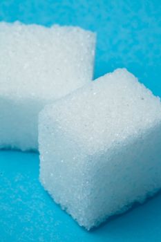 Cubes of sugar against a blue background
