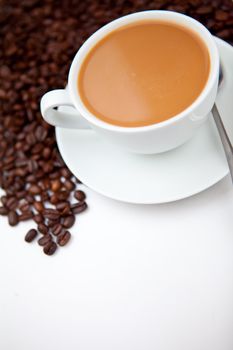 White coffee with beans against a white background