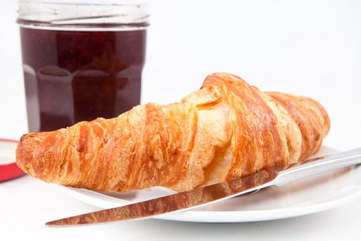 Croissant on a plate against a white background