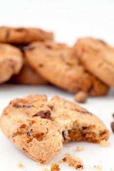 Tasted cookie in front of a stack of cookies against a white background