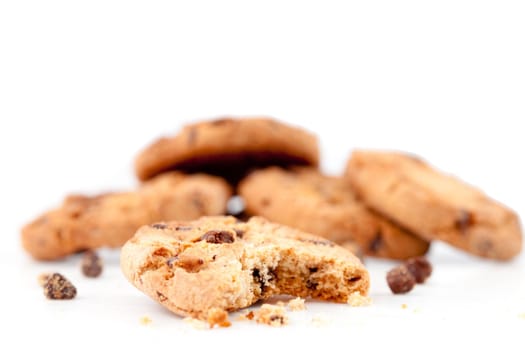Half-eaten cookie in front of a stack of cookies against a white background